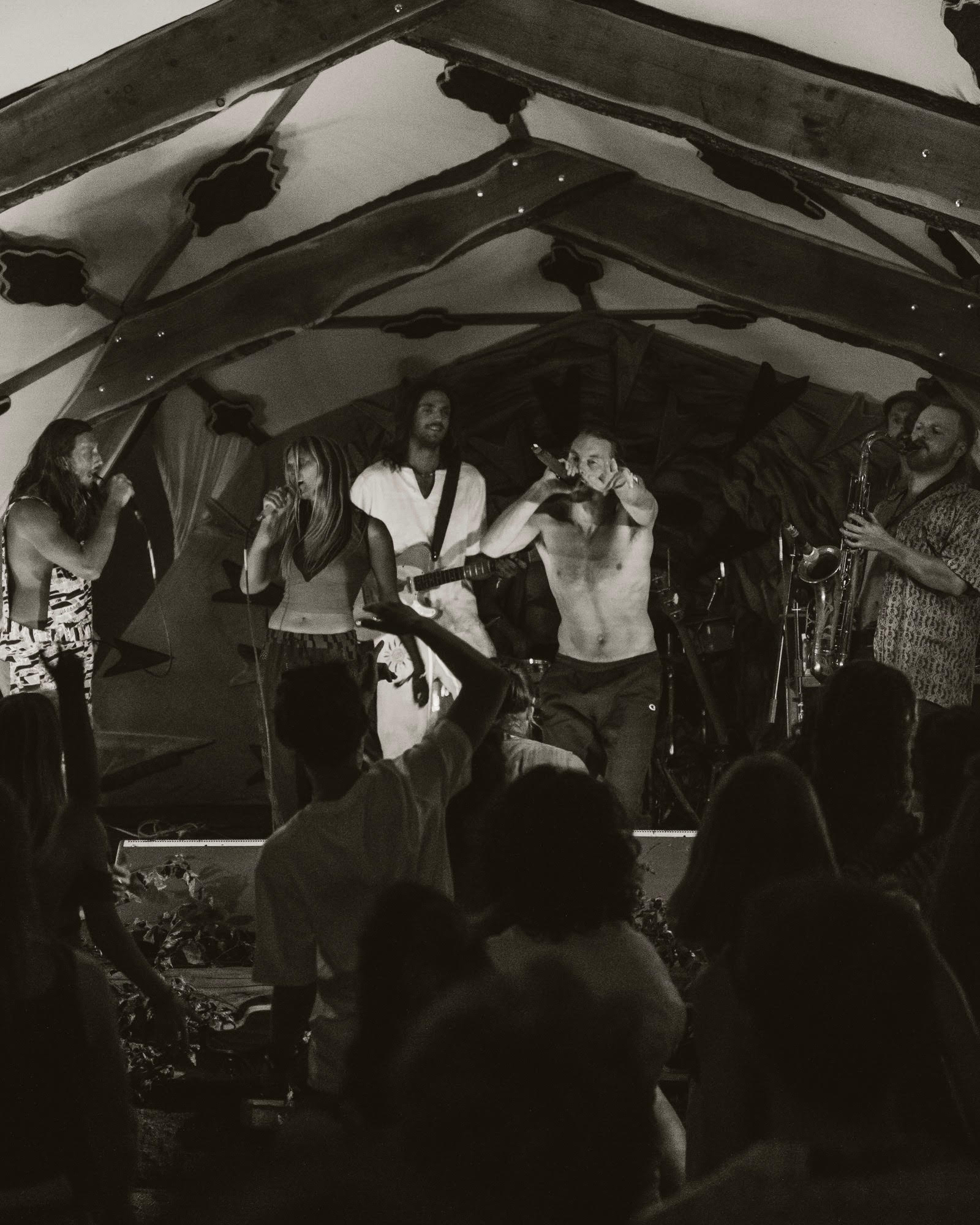 Full band on stage with saxophone and crowd dancing