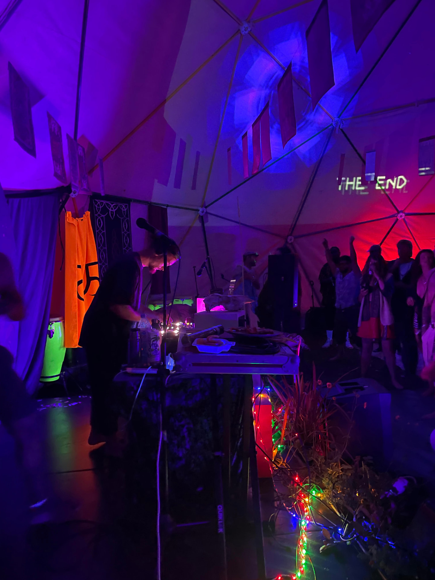 DJ setup in a geodesic dome with neon lighting